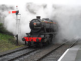 Steam train arriving at Winchcombe